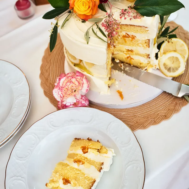 Angeschnittene Hochzeitstorte mit Zitronen und Blumendekoration im SchlossFUN Seeburg