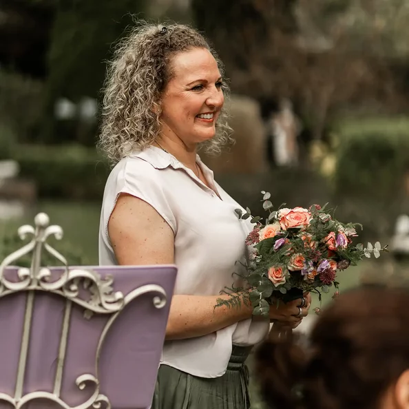 Freie Traurednerin mit Brautstrauß bei einer Hochzeit im SchlossFUN Seeburg